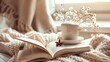 © Galib - Closeup of a cup of coffee, a book, and a vase of white flowers on a soft blanket.