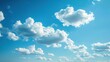© Thanedpol - A serene sky background with soft, fluffy clouds drifting across a clear blue expanse, capturing the peaceful and infinite beauty of the sky, ideal for uplifting and tranquil designs, travel