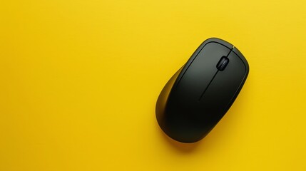 A black computer mouse on a yellow background.