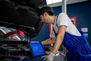 Professional Auto Mechanic Performing Vehicle Inspection with Digital Tablet in Modern Automotive Garage