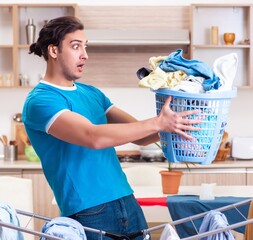 Sticker - Young man husband doing clothing ironing at home