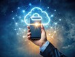 © kittipon - A hand grasps a smartphone with a radiant cloud symbol hovering above, representing the transformative impact of digital documentation and efficient business management solutions.