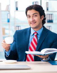 Wall Mural - Young handsome businessman in front of whiteboard