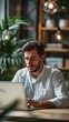 © Spectrum Sculptor - Handsome focused man working using laptop sitting at office desk table in coworking workspace. Businessman freelancer, executive manager or employee making report, searching . Vertical, Generative AI