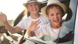 © maxximmm - Child is traveling in car with window down. travel adventure vacation concept. a group of kids are having an adventure driving a car. a group of children riding in a lifestyle car,.