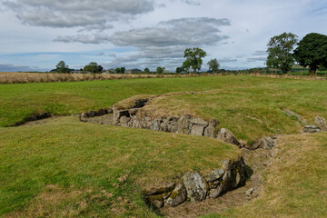 The remains of the Iron age Souterrain of the Carlungie Earth House within the arable farm fields and gently rolling hills near Dundee.