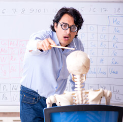 Wall Mural - Young male chemist teacher and student skeleton