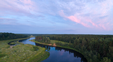 Aufkleber - A river with a forest on either side. The water is calm and the sky is a mix of blue and purple