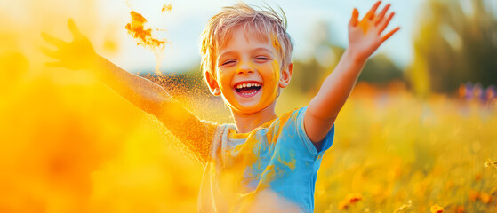 A young boy is standing in a field of yellow flowers, wearing a blue shirt