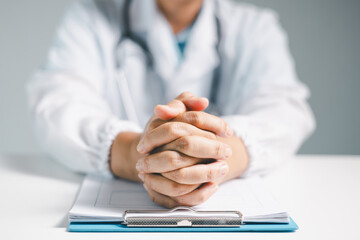 Poster - Doctor clasped their hands in prayer, hoping for the best as they provided medical care in hospital clinic. doctor, pray, medicine, health, medical, hand, hospital, care, clinic, hope, prayer, person.