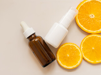 face serum and cream with vitamin C, orange slices, packaging container