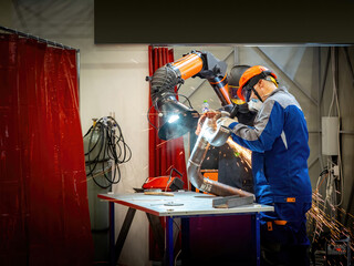 Poster - Man works at industrial enterprise. Worker with circular saw. Production of pipes with bends in workshop. Man worker grinds weld on pipe. Pipeline production during construction. Pipe maker