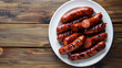 © Michael - Delicious chorizo sausages on a rustic wooden table, a mouthwatering spanish and portuguese dish with spicy paprika-infused meat, ideal for lunch or dinner
