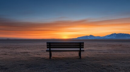 Wall Mural - a lone bench overlooking a vast, golden sunset, with a clear expanse of sky for copy