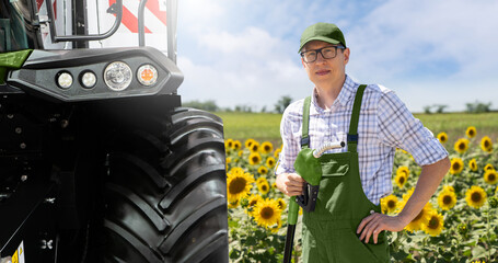 Wall Mural - Man with biofuel refueling nozzle next to agricultural machines