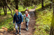 © Davor - Family wearing outdoor gear and backpacks hiking in forest