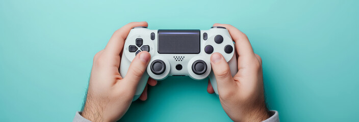 Man using wireless game controller on light blue background, closeup