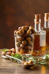 Canvas Print - Spicy olives and bottles of olive oil on a wooden table.