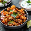 © nitiroj - Indian snack of crispy herbspiced muthia with a side of yogurt dip