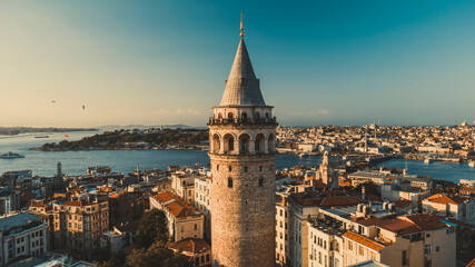 Galata tower. Close-up photo of Galata Tower, one of the few beauties of Istanbul, taken with a drone at sunset. Magnificent view of the sea and buildings in the background.