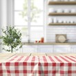 © zz - Cozy Kitchen Setting Featuring Red Checkered Tablecloth With Natural Light Streaming In