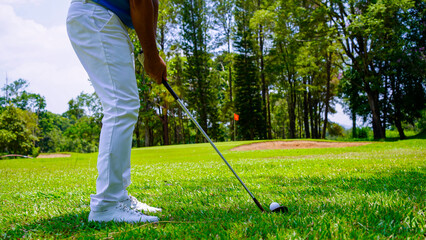 Wall Mural - Golfers are playing golf in the evening golf course golf backglound.