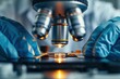 © sornthanashatr - A scientist is looking through a microscope at a small object