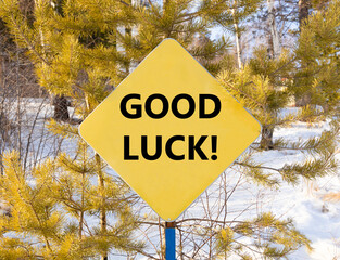 Poster - Good luck symbol. Concept words Good luck on beautiful yellow road sign. Beautiful forest snow blue sky background. Business, motivational good luck concept. Copy space.