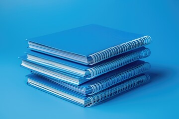 Aufkleber - Stack of blue notebooks on a blue surface