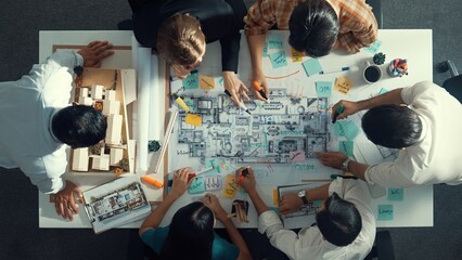 Poster - Top aerial view of project manager or civil engineer writing at blueprint and planning building design. Aerial view of architect working together at meeting table with document placed. Alimentation.