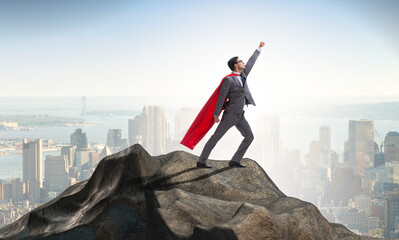 Wall Mural - Superhero businessman on top of mountain