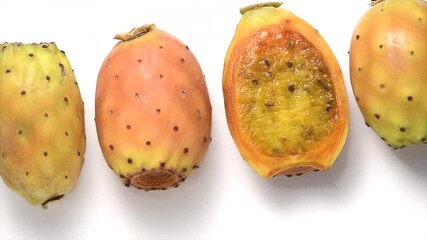 Canvas Print - Prickly pear cactus, Opuntia edible fruit macro shot. Fresh tasty sweet exotic fruits isolated on white, rotating background. Opuntia ficus indica, top view, flat lay 