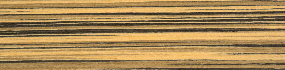 Golden hues and dark streaks dance in harmony on the rich surface of this zebrawood veneer