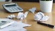 © KKC Studio - Business Failure Concept - Crumpled Business Plan on Desk with Calculator and Unpaid Bills Representing Financial Struggles