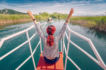 Leisure lifestyle: A happy tourist enjoying a boat tour on Lake Skadar, Montenegro.