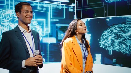 Poster - Cheerful host and expert guest talking at AI summit bringing together tech company workers, exploring latest innovations and discoveries in artificial intelligence industry, camera B