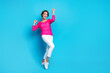 © deagreez - Full length photo of excited lucky lady dressed pink knitted shirt having fun rising fists empty space isolated blue color background