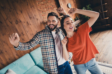 Canvas Print - Photo of attractive trendy cheerful dancing disco married young couple spending free time move new apartment home interior indoors