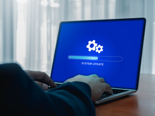 Poster - System update concept. Gear icon and updating system, loading tab bar progress operating on blue screen while businessman work with laptop computer for new improved version, restore data software.
