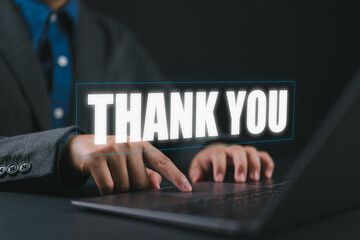 businessman using a laptop and showing the message thank you on a display screen. concept of thank you business, appreciation and gratitude, congratulations, presentation from technology digital