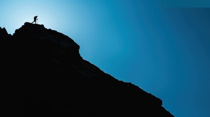 Wall Mural - Silhouette of a person hiking on a mountain ridge.