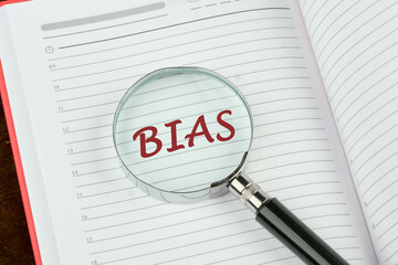 Wall Mural - Business concept. The word Bias written through a magnifying glass on a notepad page