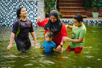 Happy Family swimming in the pool. Vacation and school holiday concept.