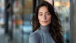 © AstraNova - portrait of attractive young woman with dark brown hair and grey long sleeve dress looking forward with bokeh city lights background