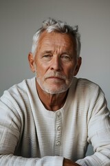 Wall Mural - Portrait of a Senior Man with Gray Hair and a White Sweater