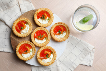 Wall Mural - Delicious canapes with shrimps, red caviar and cream cheese served on light table, flat lay