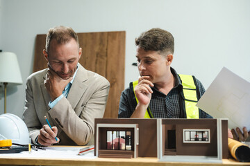 Wall Mural - Civil engineer caucasian teams discussing issues at the construction site, industry professional team.