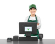 © phonlamaiphoto - Active asian seller wear green uniform smiling with point of sale terminal or cashier desk