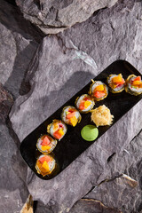 Sticker - Delicious Tempura Roll with Mango and Grapefruit on Slate Background - Eye-Catching Sushi Image for Culinary Media