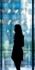 Poster - Professional woman in silhouette against a glass window.